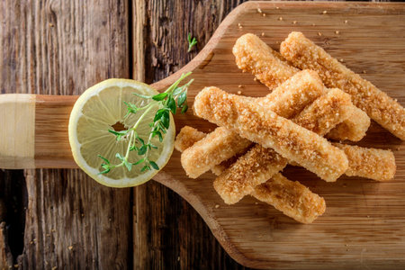 Crispy and Zesty: Panko-Breaded Fish Sticks with Lemon in Exquisite 4K Close-Uの写真素材