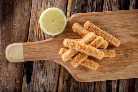 Crispy and Zesty: Panko-Breaded Fish Sticks with Lemon in Exquisite 4K Close-Uの写真素材