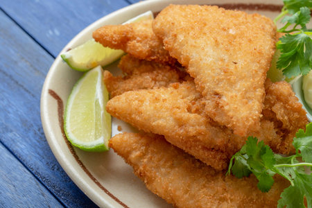 Savor the Flavor: Top a Close-Up of Deep Fried Crab over White Steamed Rice with Lemon in 4Kの写真素材