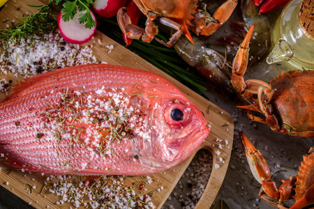 Exquisite Delights: Fresh New Zealand Red Snapper fish and Crab Infused with Salt, Spices, and Zesty Lemon in 4Kの写真素材