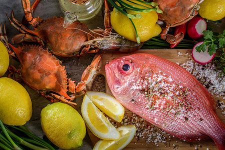Exquisite Delights: Fresh New Zealand Red Snapper fish and Crab Infused with Salt, Spices, and Zesty Lemon in 4Kの写真素材