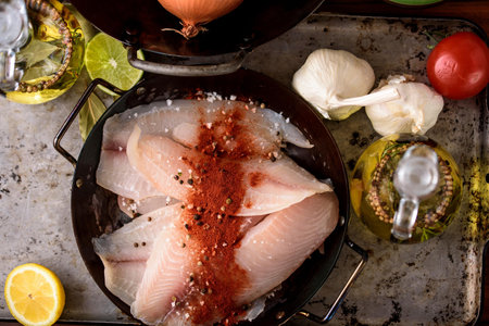 Exquisite Flavors: Close-Up of Raw Tilapia fish Fillet Infused with Delicious Spices in 4Kの写真素材