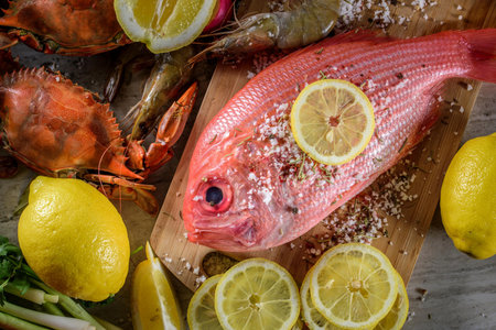 Exquisite Delights: Fresh New Zealand Red Snapper fish and Crab Infused with Salt, Spices, and Zesty Lemon in 4Kの写真素材