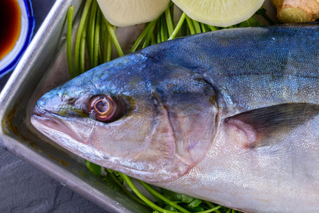 Fresh tuna fish with ingredients for cooking on dark background, top viewの写真素材