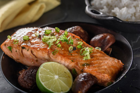 Salmon Steak with Rice and Mushrooms on Black Background.の写真素材