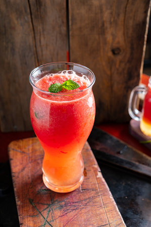 Watermelon smoothie in a glass on wooden table with copy spaceの写真素材