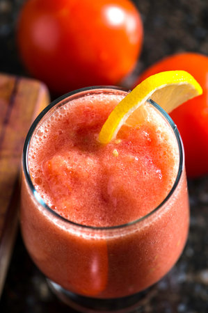 Tomato juice in a glass on a dark background, selective focus.の写真素材