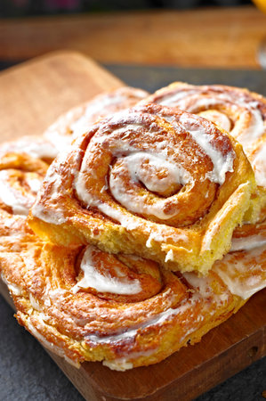 Cinnamon rolls on a cutting board, close-up, verticalの写真素材