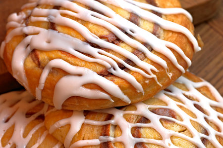 Delicious cinnamon buns on wooden table, closeup. Sweet dessertの写真素材