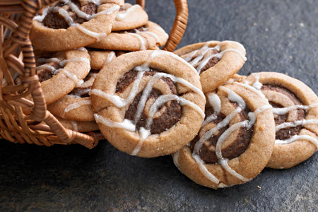cookies with chocolate chips in a wicker basket on a dark backgroundの写真素材