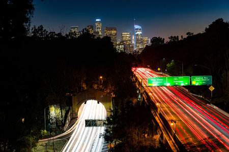 Los Angeles, California, USA downtown cityscape at dusk. Los Angeles light trails on highway.