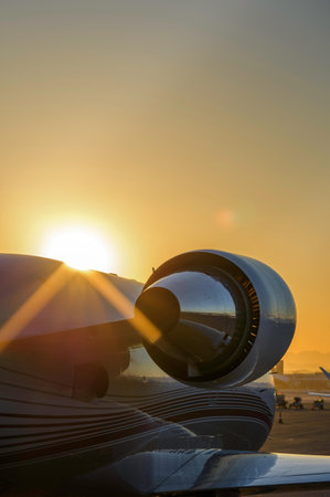 Airplane on the runway at sunset, closeup of photo.の写真素材