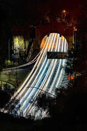 Night traffic light trails on the bridge over the river in the cityの写真素材