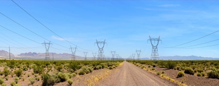 Panoramic view of high voltage power lines in the desert.