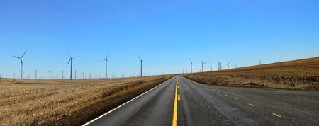 An image of a road and wind turbines in the prairie.の写真素材
