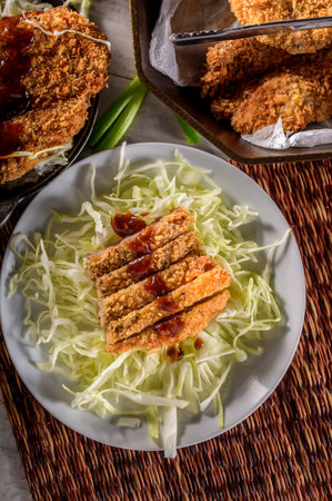 Korean fried pork cutlet with cabbage and sweet and sour sauceの写真素材