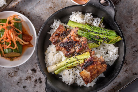 Pork belly with rice and vegetables in a cast-iron panの写真素材