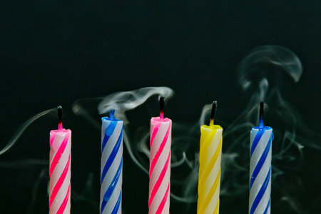 Birthday candles with smoke on black background, copy space for textの写真素材