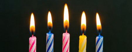 Birthday candles on a black background, close-up, selective focusの写真素材
