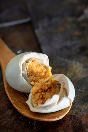steamed dumpling stuffed with pork and egg on a wooden spoon