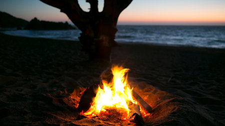Bonfire on the beach at sunset. Camping on the beach.の写真素材