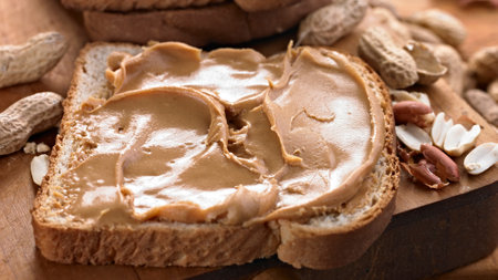Peanut butter sandwich on wooden background, close-up, horizontal