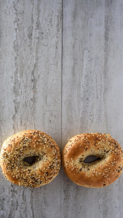 Two bagels with chocolate and sesame seeds on a gray backgroundの写真素材