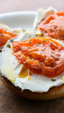 Sandwich with egg, tomato and mozzarella on wooden tableの写真素材