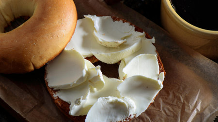 Bagel with cream cheese and cup of coffee, closeupの写真素材