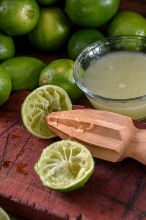 Lime juice in a glass and fresh lime on wooden background.の写真素材