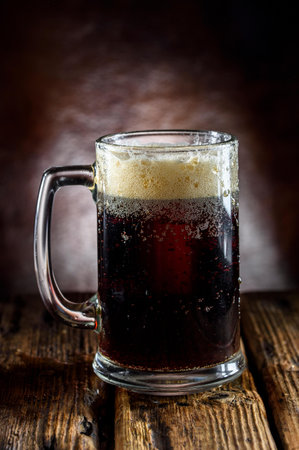 cold beer in a glass on a dark background. tinting. selective focus