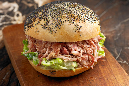 sandwich with tuna, lettuce and mayonnaise on wooden board