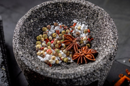 Spices in mortar and pestle on black background. Close up.