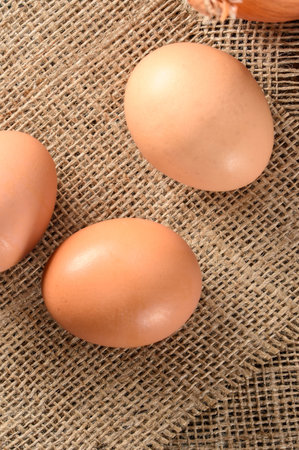 Eggs on burlap background. Top view, flat layの写真素材
