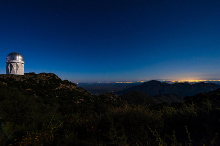 Observatory in the mountains at night with stars in the skyの写真素材