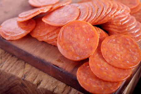 Slices of salami on a cutting board. Selective focus.の写真素材