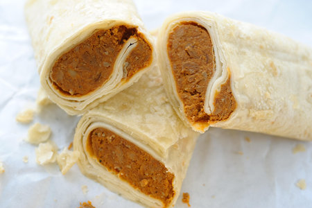 Pancakes stuffed with meat and rice on a white background.