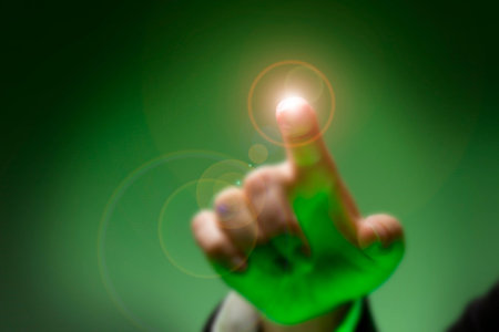 Businessman showing thumbs up sign with green light bokeh backgroundの写真素材