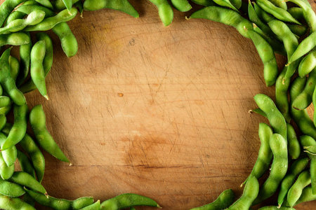 Green soybeans on a wooden board. Top view with copy spaceの写真素材