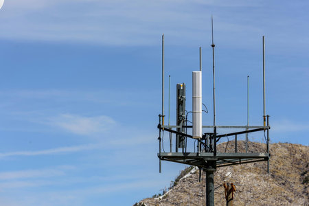 Antenna on the top of a mountain with blue sky background.
