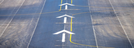 Airport runway with two arrows in a row. View from above.