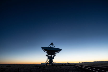The silhouette of a radio telescope observatory at dawn. Long exposure photograph.の写真素材
