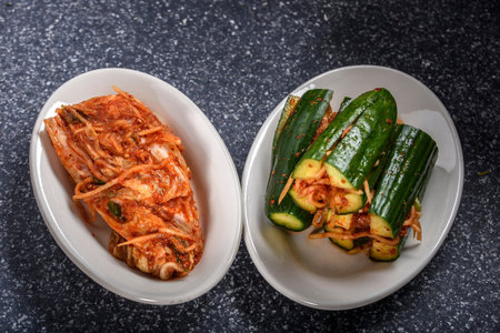 Korean food, Kimchi and cucumber on a white plateの写真素材