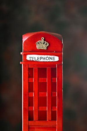 Traditional red British telephone box on dark background with copy space for your textの写真素材