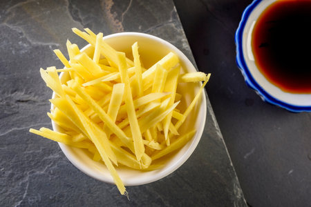 Sliced Grated Cheese in a bowl with soy sauce.の写真素材