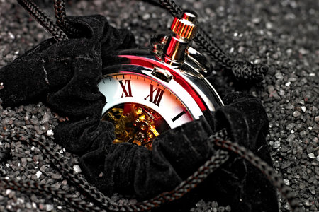 Pocket watch on a black background with sequins. Time concept.の写真素材