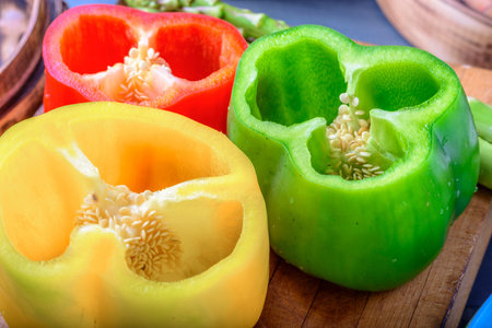 Slices of bell pepper on a wooden cutting board close upの写真素材