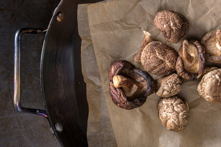 Shiitake Mushrooms in a Cast Iron Pan on Paperの写真素材
