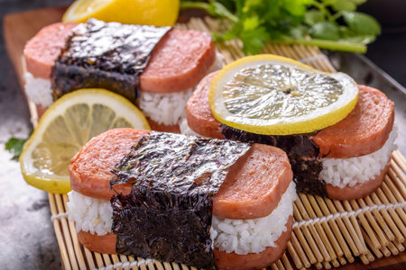 Salmon sushi with rice and lemon on a rustic background.の写真素材
