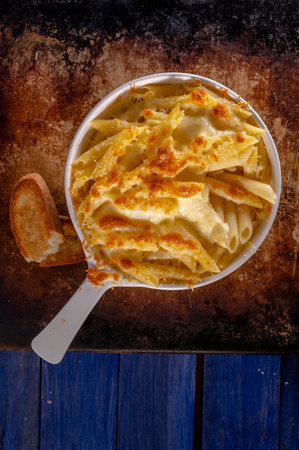 Pasta with cheese and croutons on rustic wooden background